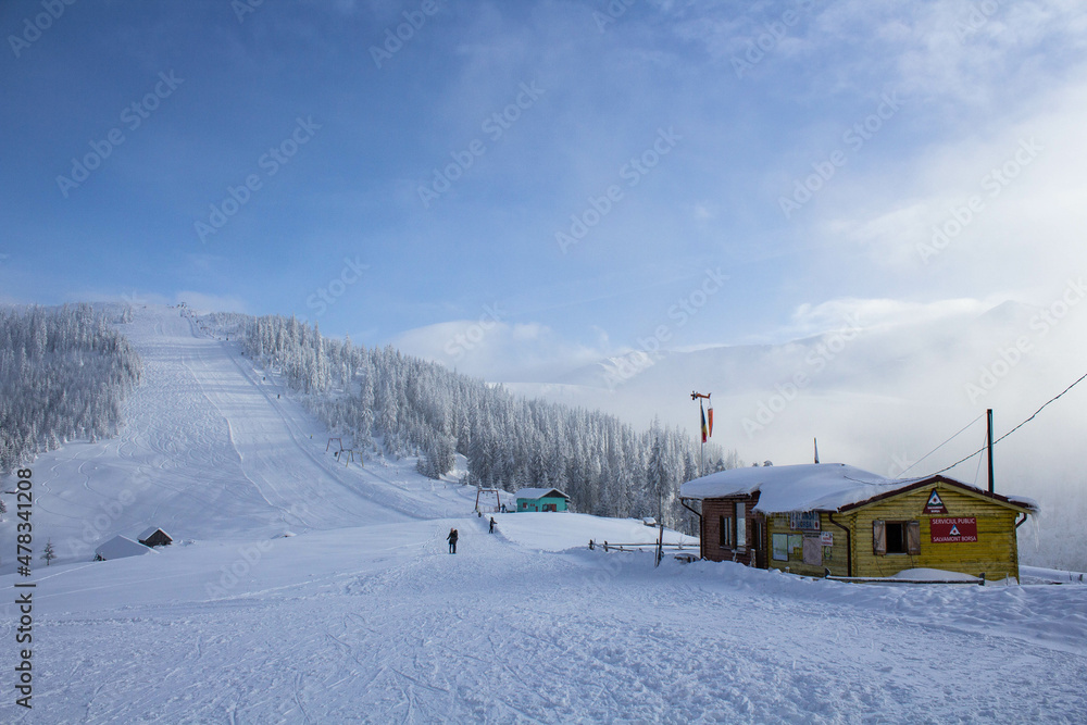 Beautiful snowy landscape of a rescue house on sky slope