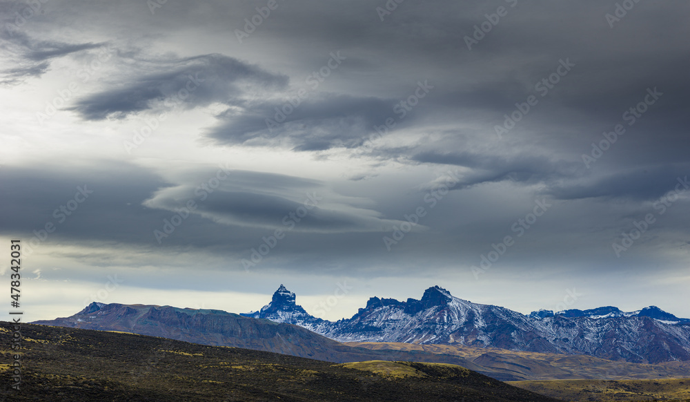 Jagged mountains in the mountain range Sierra Baguales under dark threatening sky, Patagonia, Chile