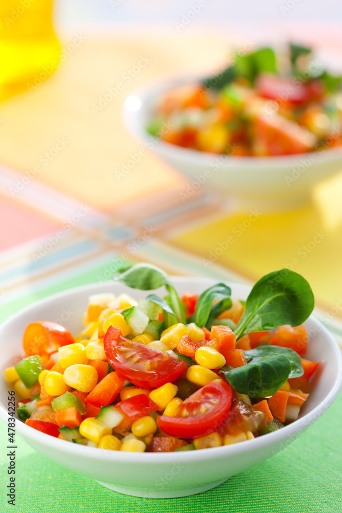 Healthy vegetarian vegetable salad with corn, tomatoes and cucumber