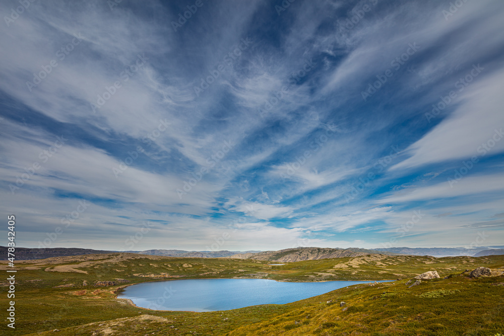 Tundra landscape in west Greenland with lake and cirrus clouds