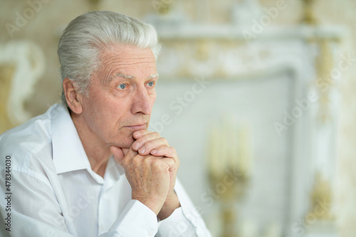 Portrait of beautiful sad thinking senior man posing