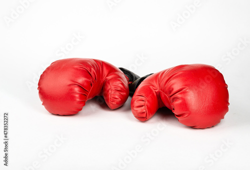 Red boxing gloves against white background.