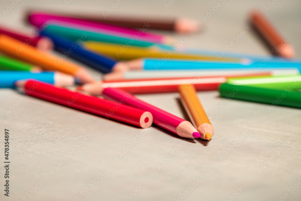 School pencils are scattered on gray background.