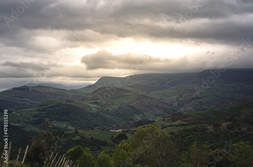 Cloudy sky over green mountain range