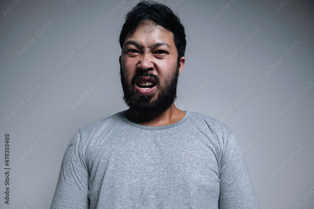 Obraz premium Asian handsome man angry on white background,Portrait of young Stress male concept