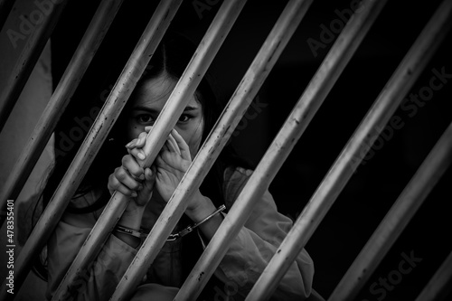 Obraz na płótnie Portrait of women desperate to catch the iron prison,prisoner concept,thailand people,Hope to be free,If the violate the law would be arrested and jailed
