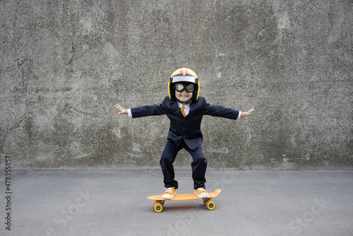 Funny businessman riding skateboard outdoor