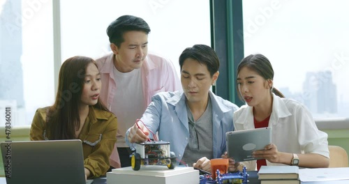 Business group Startup are brainstorming electric vehicle model design project. Automotive technicians are using technology to work with team in co-working space. Innovation to create modern artifact