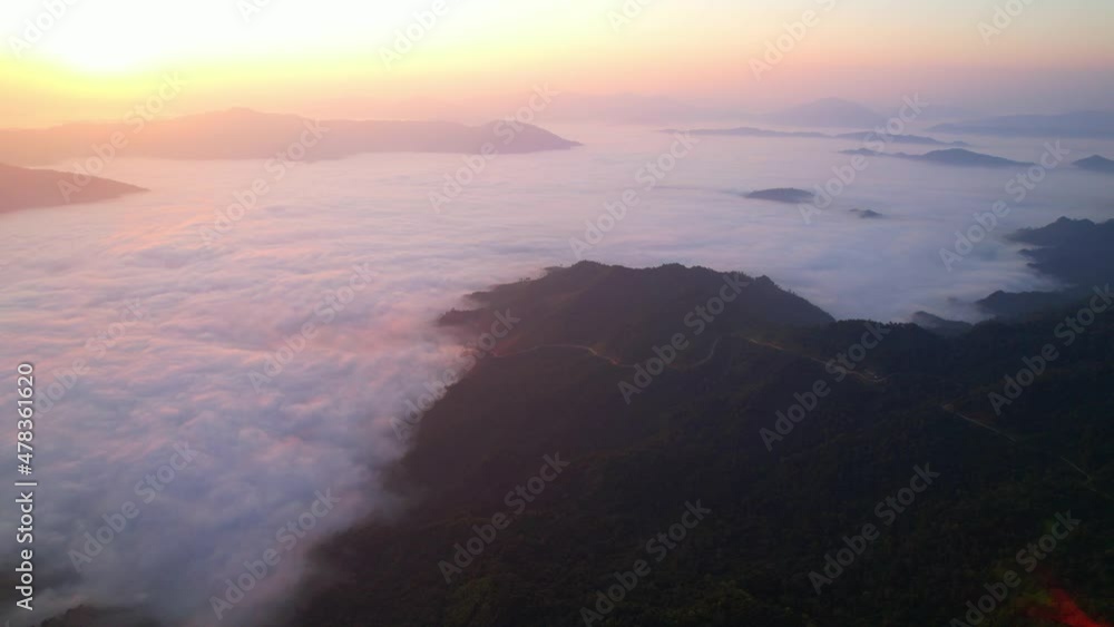 4K Aerial view from drone over mountains and sea of fog. Golden scenery at sunrise 4K Aerial view from drone over mountains and sea of fog. Golden scenery at sunrise