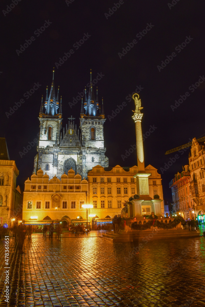 Old square with cathedral and column at night