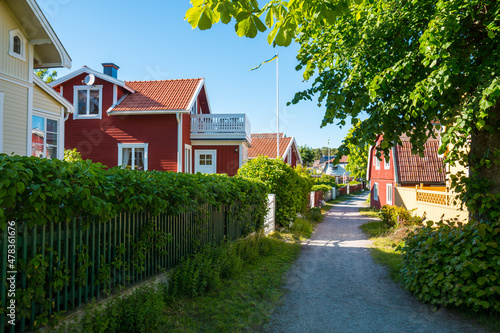Street view in Sandham, Sweden. Village house, garden and footpath