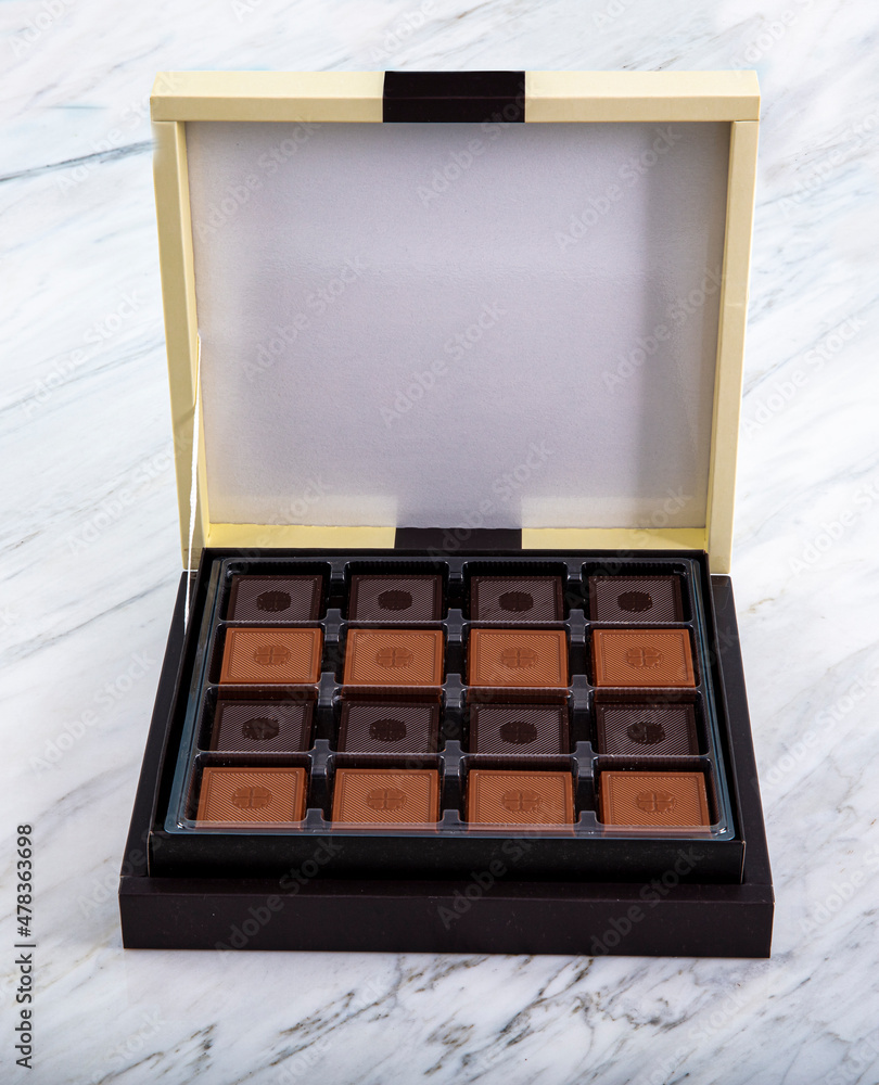 Madlen Chocolate, Square Chocolate Pack on marble floor. Milk and dark square chocolate Madlen is designed geometrically. Candy Day or any festival celebration. Madlen Chocolate, Square Chocolate Pack on marble floor. Milk and dark square chocolate Madlen is designed geometrically. Candy Day or any festival celebration.
