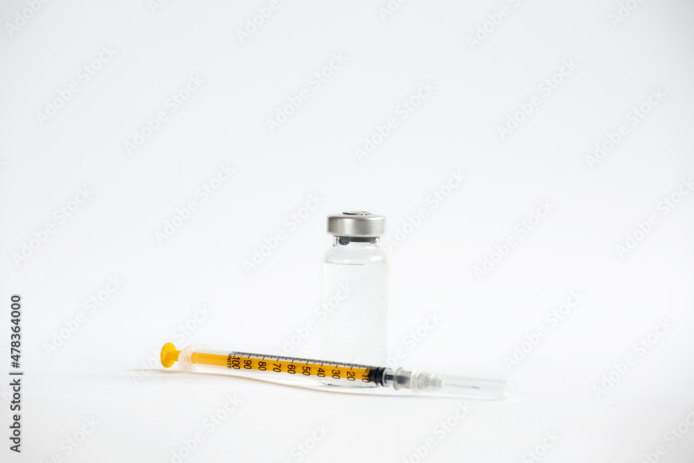 The vaccines vials glass bottle and disposable syringe on white The vaccines vials glass bottle and disposable syringe on white