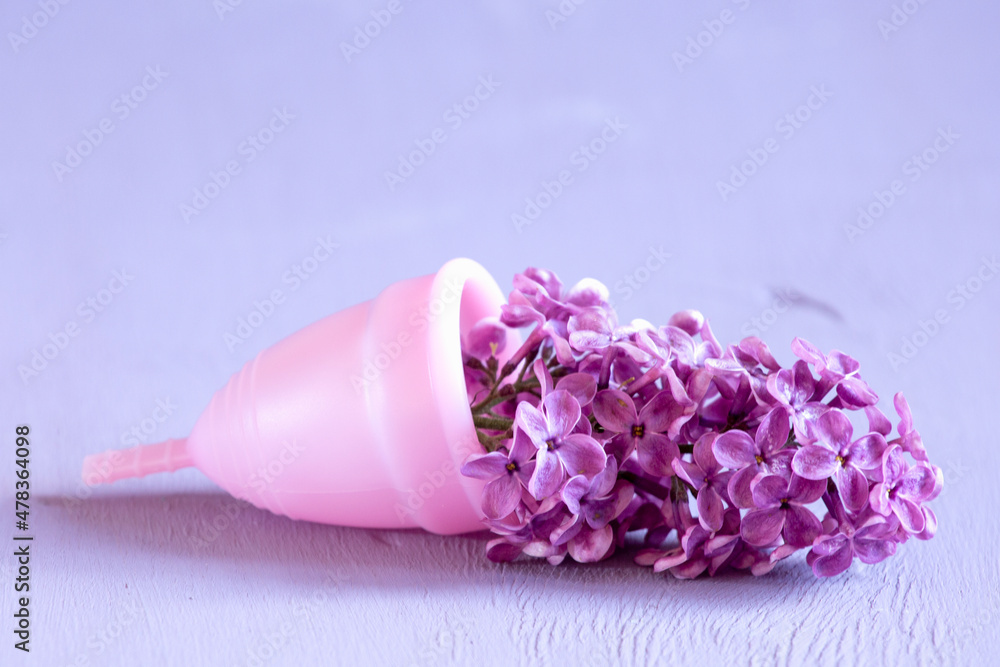 Menstrual cup on violet background. - obrazy, fototapety, plakaty 
