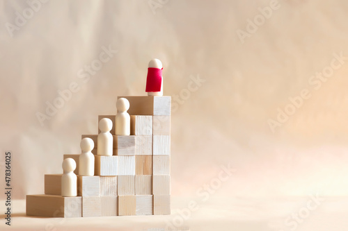 Career Growth Concept. Wooden model on red coat climbing on ladder.