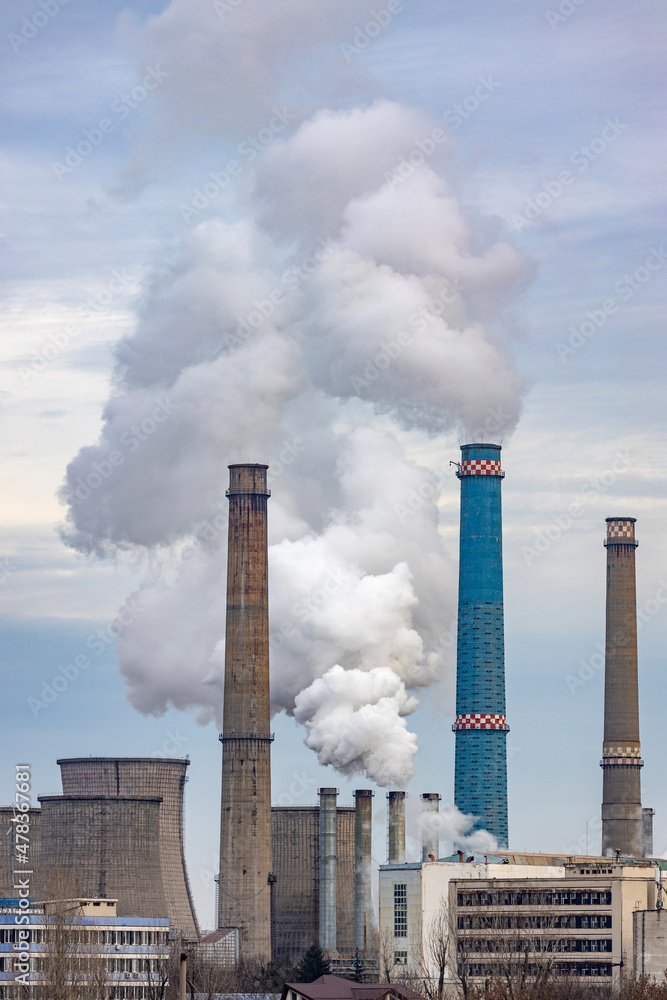 Thermal power station in Bucharest, Romania. The factory chimney is polluting the atmosphere. Thermal power station in Bucharest, Romania. The factory chimney is polluting the atmosphere.