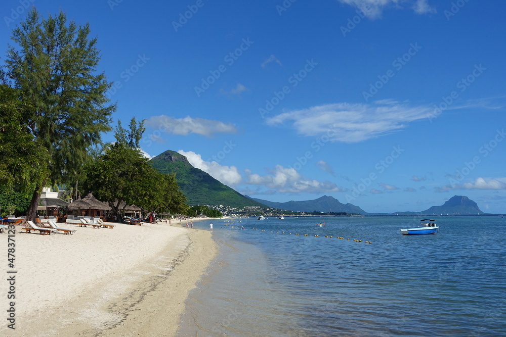 Scenic view of a tropical beach with white sand, calm sea and beautiful sky