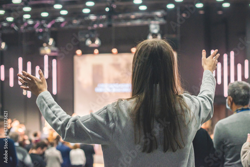 Hands in the air of a woman who praise God at church service photo