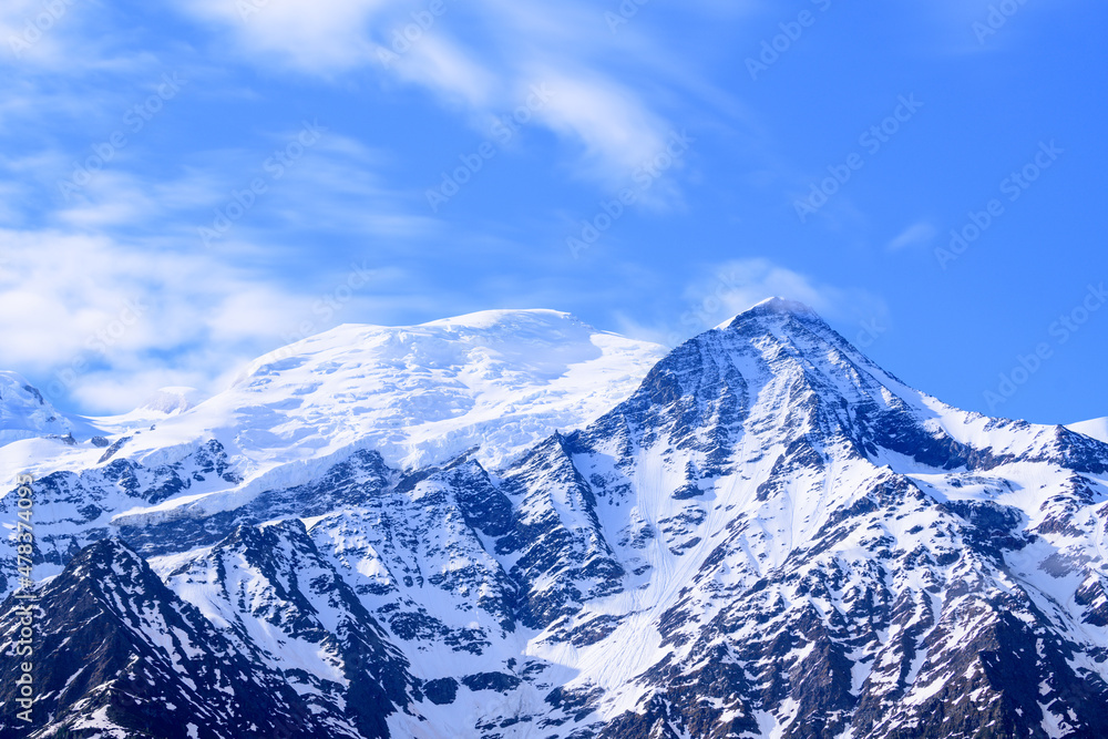 Clouds moving over Mont Blanc and the Aiguille du Gouter in Europe, France, the Alps, towards Chamonix, in summer, on a sunny day. Clouds moving over Mont Blanc and the Aiguille du Gouter in Europe, France, the Alps, towards Chamonix, in summer, on a sunny day.