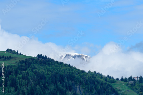 Mont Joly and Col de Voza in the clouds in the Mont Blanc massif in Europe, France, the Alps, towards Chamonix, in summer, on a sunny day. photo