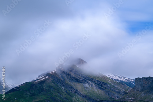 Clouds moving from the top of the mountain Roches Merles in Europe, France, the Alps, towards Chamonix, in summer, on a sunny day.