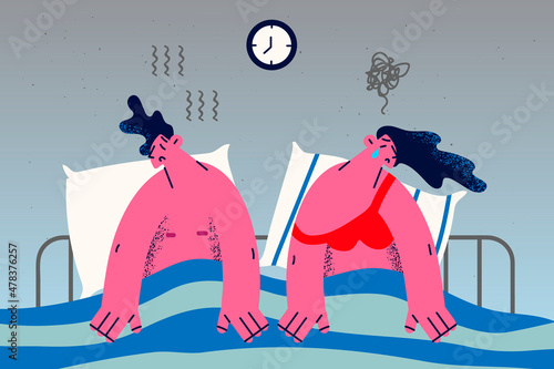 Stressed couple in bed having relationship problems 