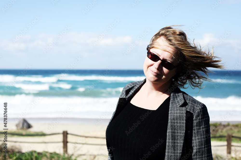 Portrait of happy and real 45 years old woman at seashore Portrait of happy and real 45 years old woman at seashore