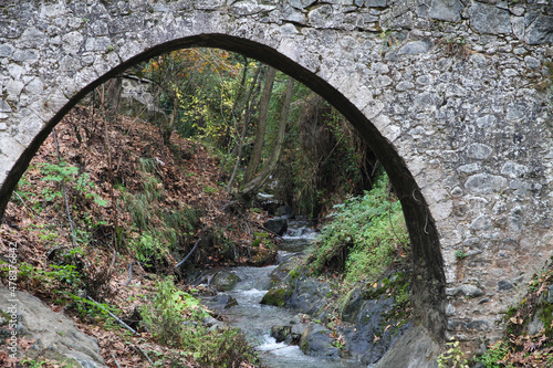 view through famous old stone bridge at Monastery of Agios Ioannis Lampadistis, in troodos mountains in Kalopanagiotis, cyprus