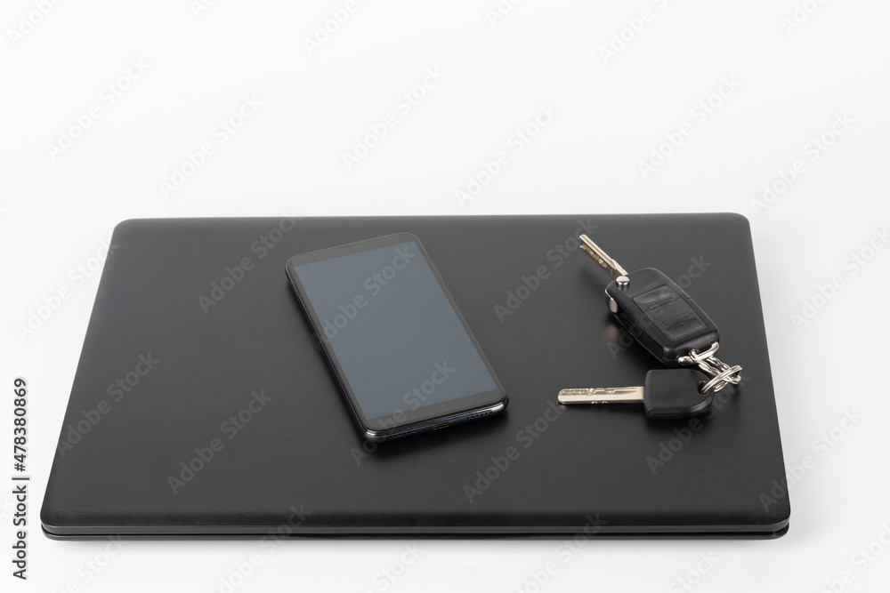 Modern office black laptop and touchscreen smarthphone and car keys, business concept. Modern office black laptop and touchscreen smarthphone and car keys, business concept.