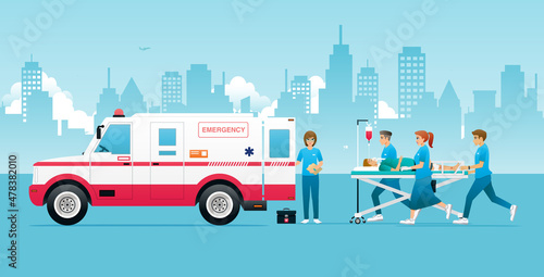 Emergency medical workers are rushing to get the accident victims into the ambulance.