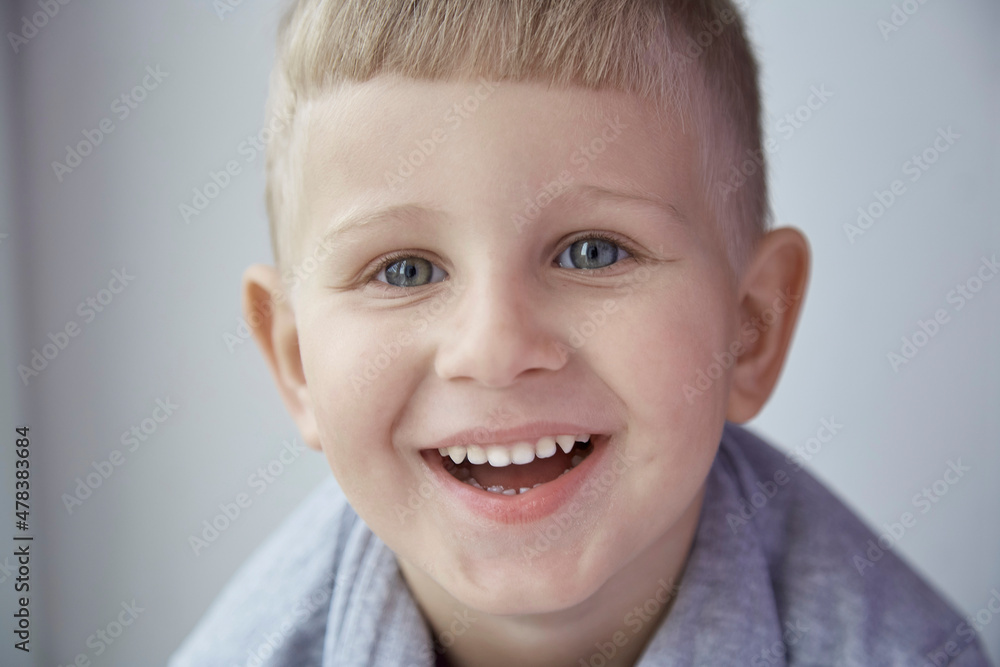 Portrait of cute smiling boy looking to the camera close up. Childhood, collage, stomatology concept. Happy expression Portrait of cute smiling boy looking to the camera close up. Childhood, collage, stomatology concept. Happy expression