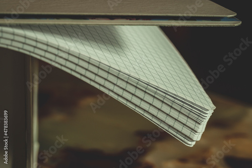 Notepad with checked sheets on table
