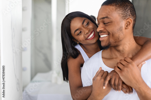 Portrait Of Romantic African American Couple Embracing In Bathroom In The Morning