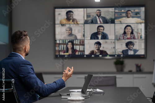 Arabic CEO having video conference with his team, office interior photo