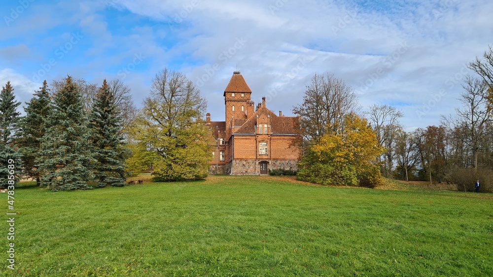 Beautiful old Latvian castle Jaunmoku among trees with yellowed leaves October 16, 2021