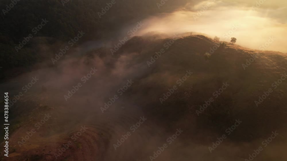 4K Aerial view from drone over mountains and sea of fog. Golden scenery at sunrise 4K Aerial view from drone over mountains and sea of fog. Golden scenery at sunrise