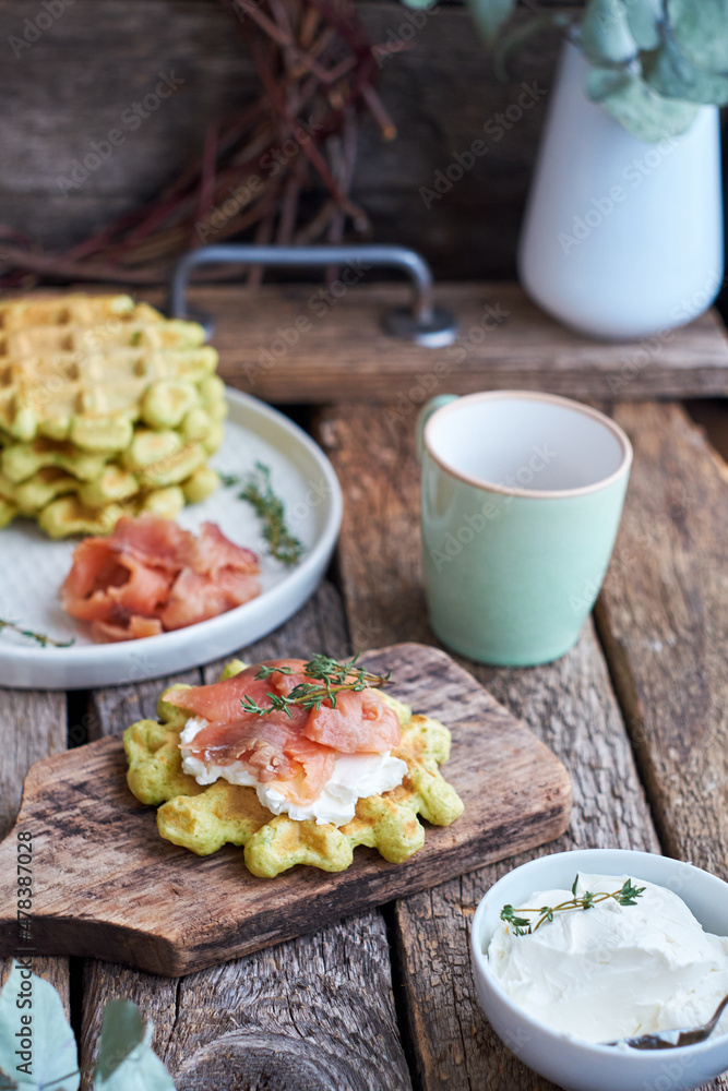 Belgian avocado waffles with salmon. Side view, wooden background. Rustic. Belgian avocado waffles with salmon. Side view, wooden background. Rustic.