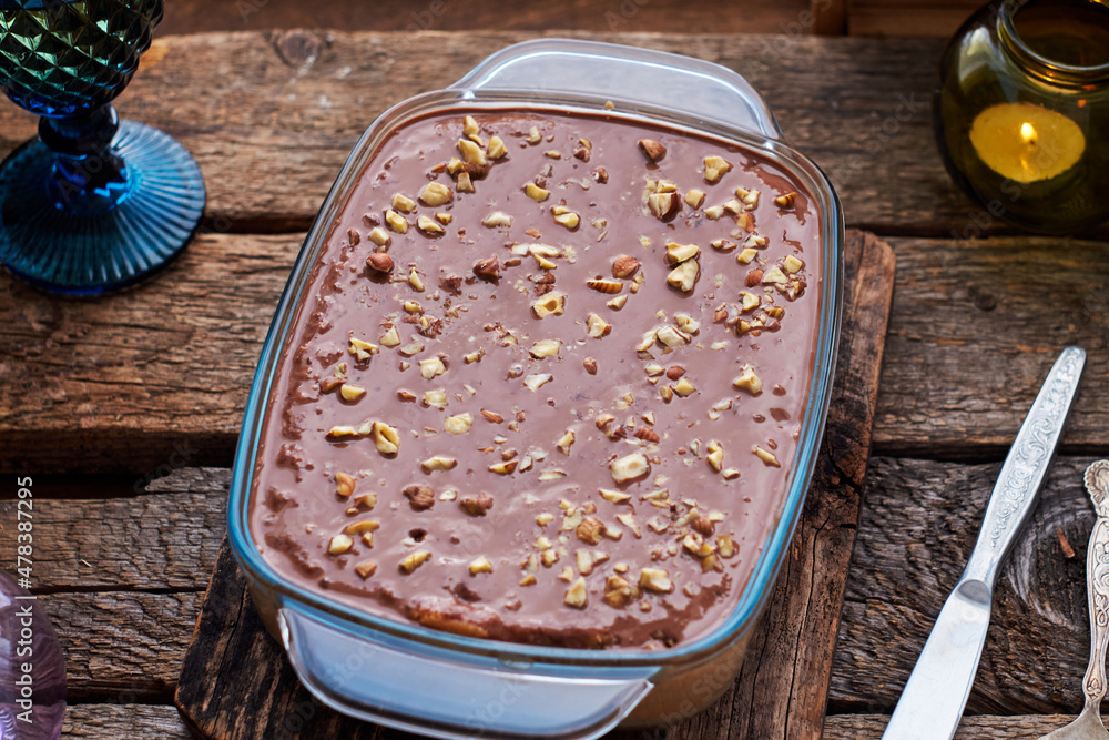 homemade chocolate cake with nuts, side view, wooden background. homemade chocolate cake with nuts, side view, wooden background.