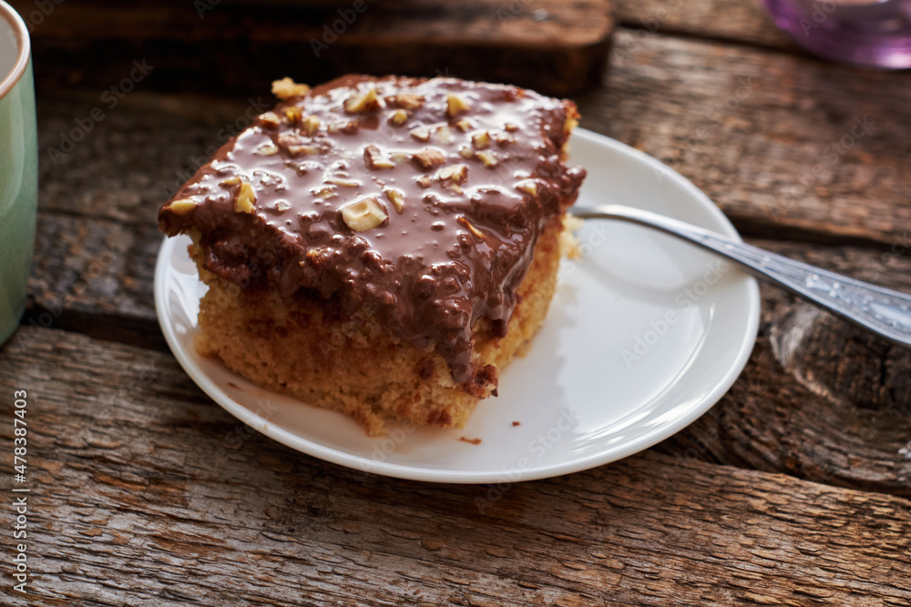 homemade chocolate cake with nuts, side view, wooden background. homemade chocolate cake with nuts, side view, wooden background.