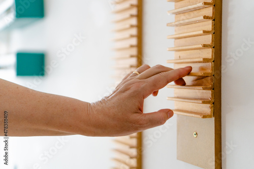 Canvas Print older woman's hand in occupational therapy, doing exercises to rehabilitate tendinitis in her shoulder