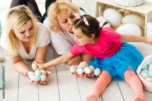 happy family with easter eggs. Happy llittle girl and grandmother with Easter eggs photo