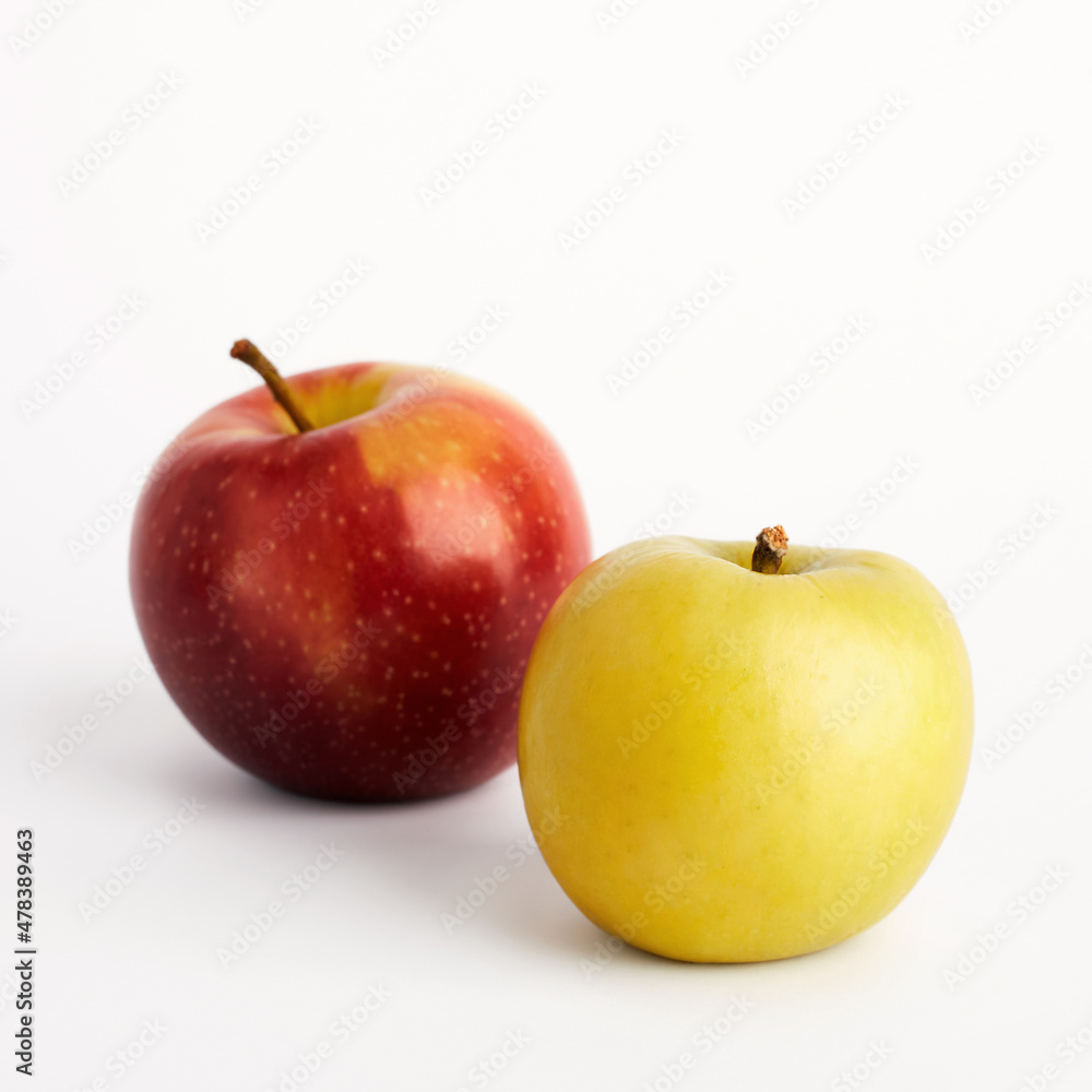 Yellow and red apples isolated on white background. Selective focus Yellow and red apples isolated on white background. Selective focus