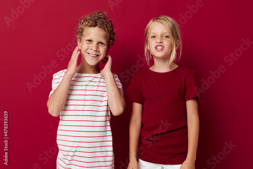 picture of positive boy and girl fun childhood entertainment on colored background