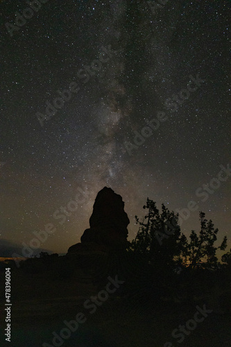 Milky Way nightscape over boulder