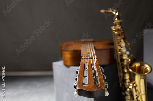 Acoustic guitar and saxophone at floor. Music concept in studio with musical instrument