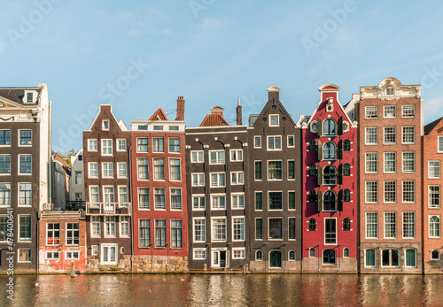 Photography Typical Dutch Amsterdam houses at the Amsterdam canal Damrak on a sunny day, Holland, Netherlands