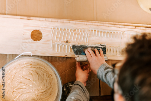 Worker laying and gluing parquet flooring. Worker installing hardwood flooring during house building photo