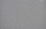 Dark gray monochrome background with a scattering of small silvery blotches.