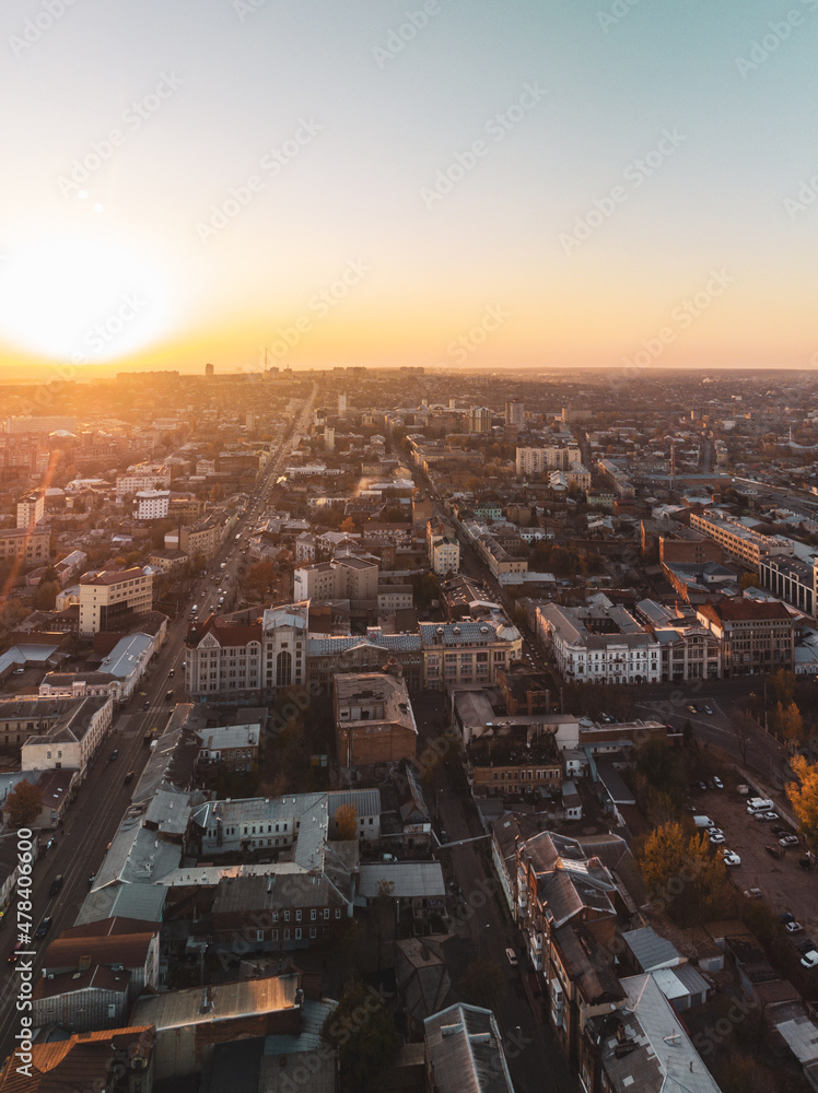 Sunny city aerial flight above autumn Zalopan district houses, downtown city streets rooftop in Kharkiv, Ukraine. Vertical pano