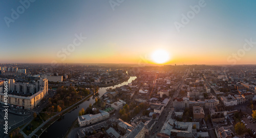 Sunny panorama, aerial view on river Lopan embankment with Skver Strilka park in Kharkiv, Ukraine. Blue clear autumn cityscape, city streets photo
